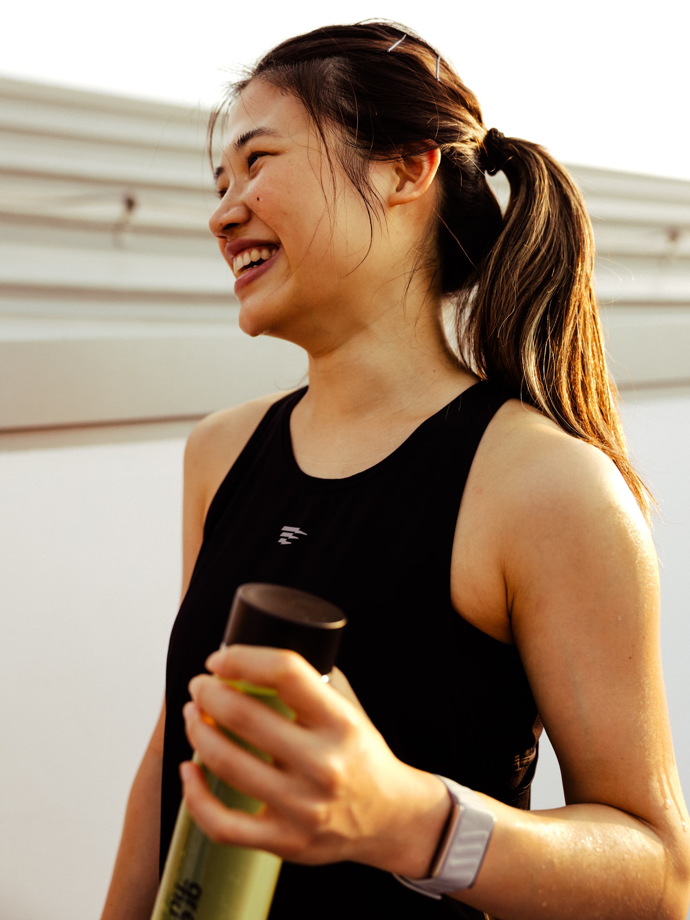 Athlete laughing while holding a Great Human bottle