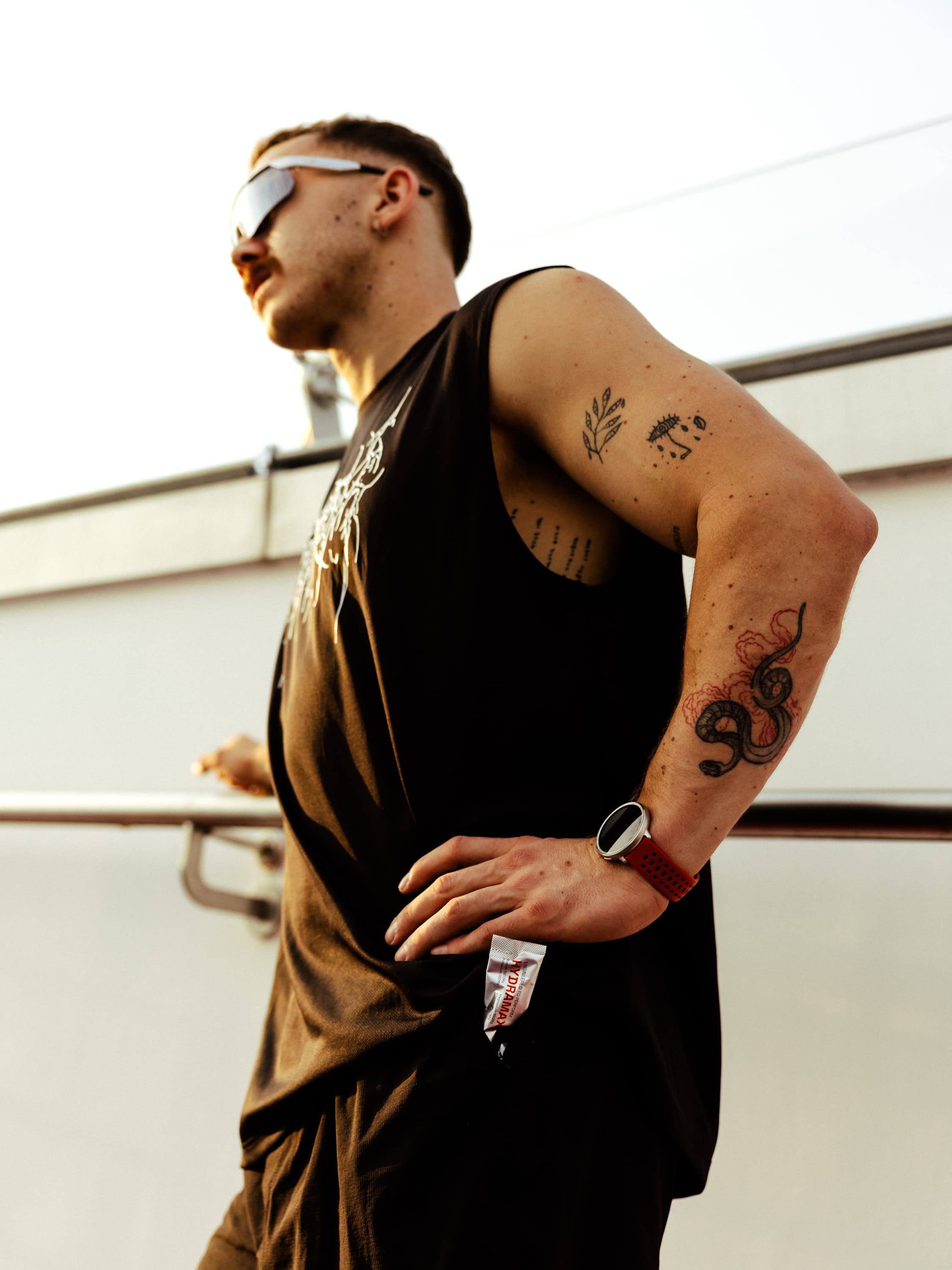 Athlete with a HYDRAMAX sachet at golden hour