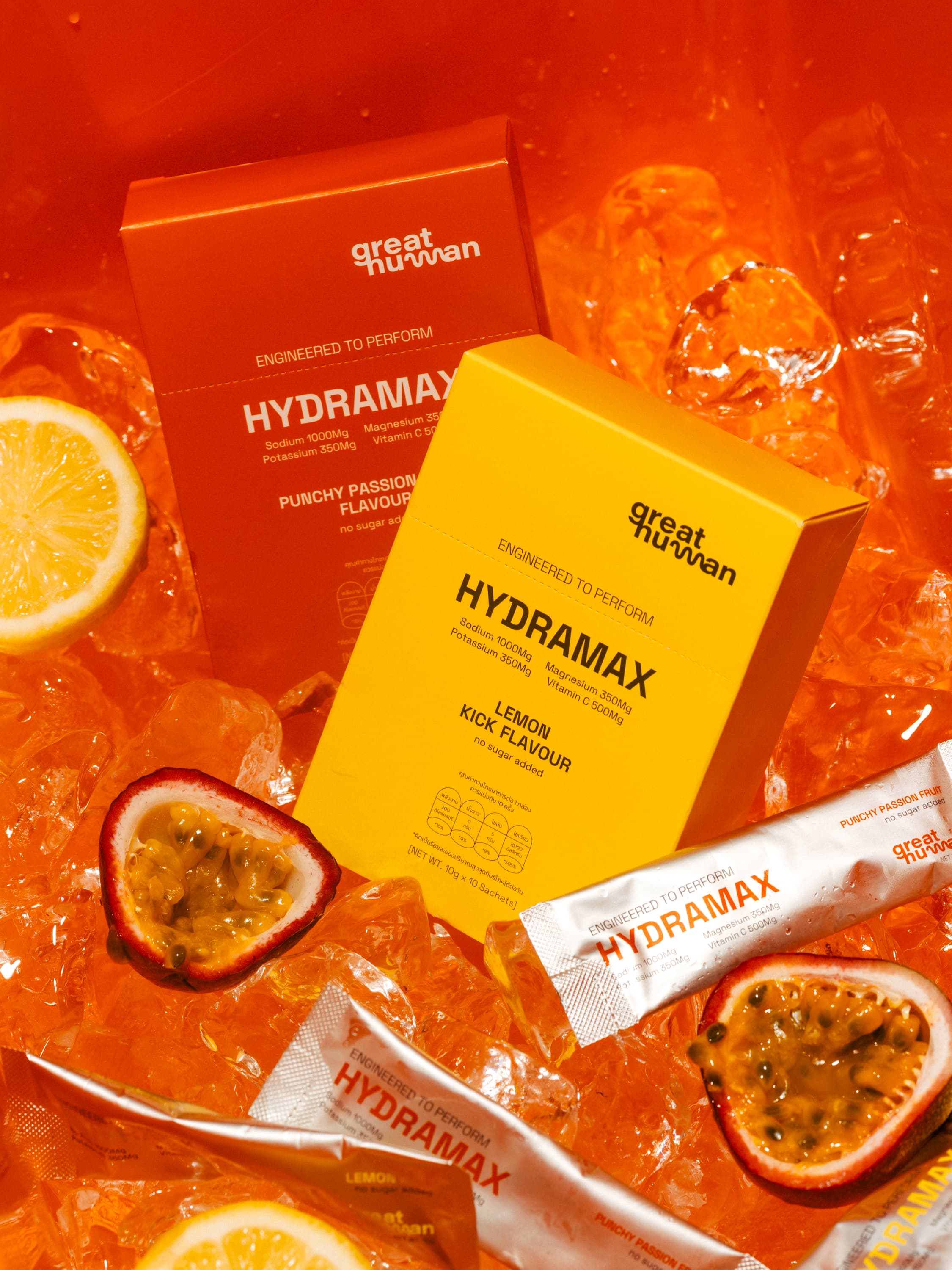 HYDRAMAX Punchy Passion Fruit and Lemon Kick boxes on ice with fresh passion fruit and lemon